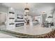 Open-concept living room featuring a fireplace, modern kitchen, and dining space at 2412 Gold Dust Dr, Clermont, FL 34715