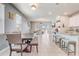 Bright, open living area featuring dining space, kitchen island, and sliding glass doors at 2412 Gold Dust Dr, Clermont, FL 34715