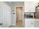 Pantry with white cabinets and granite counter, offering ample storage with easy access to laundry room at 2412 Gold Dust Dr, Clermont, FL 34715