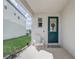 Welcoming front porch with a white chair, green door, and ample natural light at 2412 Gold Dust Dr, Clermont, FL 34715