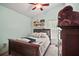 Cozy bedroom with wood-frame bed, dresser, carpet floors, and ceiling fan at 2515 Wekiva Walk Way, Apopka, FL 32703