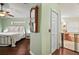 Light green bedroom featuring hardwood floors, ensuite bathroom, and walk in closet at 2515 Wekiva Walk Way, Apopka, FL 32703