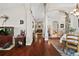 Long hallway connects living spaces, and features wood floors and natural light at 2515 Wekiva Walk Way, Apopka, FL 32703