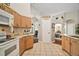 Kitchen with light wood cabinets, breakfast bar, and tiled flooring at 2515 Wekiva Walk Way, Apopka, FL 32703