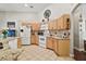 Bright kitchen with light wood cabinetry, tiled floor, and modern appliances at 2515 Wekiva Walk Way, Apopka, FL 32703