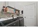 Convenient laundry room with updated appliances and storage cabinets at 2515 Wekiva Walk Way, Apopka, FL 32703