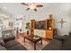Open-concept living area with hardwood flooring and views into the kitchen at 2515 Wekiva Walk Way, Apopka, FL 32703