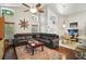 Living room featuring high ceilings, a ceiling fan, and a comfortable leather sofa at 2515 Wekiva Walk Way, Apopka, FL 32703