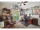 This home office includes natural light, built-in bookshelves, and comfortable seating at 2515 Wekiva Walk Way, Apopka, FL 32703
