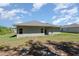 Lawn and backyard featuring a covered patio and side yard at 2808 Sw 139Th St, Ocala, FL 34473