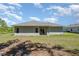 Spacious backyard view of the house, featuring a covered patio and ample lawn space at 2808 Sw 139Th St, Ocala, FL 34473