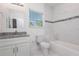 Well-lit bathroom featuring granite countertops, tiled shower, and window at 2808 Sw 139Th St, Ocala, FL 34473