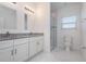 Bright bathroom featuring double vanity, granite counters, and a glass-enclosed shower at 2808 Sw 139Th St, Ocala, FL 34473