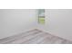 Small bedroom showcasing light wood flooring and a window at 2808 Sw 139Th St, Ocala, FL 34473