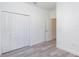 Bedroom with wood-look flooring and closet with bi-fold doors at 2808 Sw 139Th St, Ocala, FL 34473