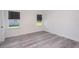 Empty bedroom showcasing light wood flooring and natural light from two windows at 2808 Sw 139Th St, Ocala, FL 34473