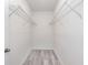 Walk-in closet with installed shelving and light wood flooring at 2808 Sw 139Th St, Ocala, FL 34473