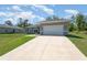 Desirable property features a well-kept lawn, a driveway to the garage, and a modern exterior at 2808 Sw 139Th St, Ocala, FL 34473