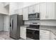 Modern kitchen featuring granite countertops and stainless steel appliances at 2808 Sw 139Th St, Ocala, FL 34473