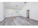 Bright living room with soaring ceilings, wood-look floors and natural light from a large window at 2808 Sw 139Th St, Ocala, FL 34473