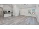 Bright, open floor plan featuring modern wood-look flooring, and seamless flow to the kitchen at 2808 Sw 139Th St, Ocala, FL 34473
