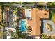 An aerial view of the backyard, pool, deck, cabana, and brown shingled roof at 2945 Southgate Ter, Orlando, FL 32818
