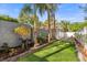 Backyard features a well-manicured garden, small trees, and fenced area at 2945 Southgate Ter, Orlando, FL 32818