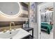 Charming bathroom featuring a unique accent wall, modern fixtures, and an illuminated mirror at 2945 Southgate Ter, Orlando, FL 32818
