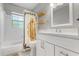 Bright bathroom featuring a combination tub and shower, and a clean white vanity at 2945 Southgate Ter, Orlando, FL 32818