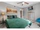Cozy bedroom with a comfortable green bed, city skyline art, and a ceiling fan at 2945 Southgate Ter, Orlando, FL 32818