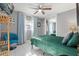 Comfortable bedroom with a large green bed, a ceiling fan, and a large mirror at 2945 Southgate Ter, Orlando, FL 32818