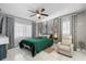 Inviting bedroom with a green bed, decorative wall accents, and a bright window with sheer curtains at 2945 Southgate Ter, Orlando, FL 32818