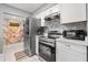 Modern kitchen with stainless steel appliances, white cabinetry, and decorative backsplash at 2945 Southgate Ter, Orlando, FL 32818