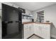 Functional kitchenette with white cabinets, butcher block countertop, and stainless steel refrigerator at 2945 Southgate Ter, Orlando, FL 32818