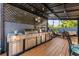 Stainless steel outdoor kitchen with a grill and counter space, under a pergola, offering a perfect outdoor cooking experience at 2945 Southgate Ter, Orlando, FL 32818