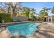 Beautiful backyard pool area with stone patio, lounge chairs, and an outdoor dining and kitchen area for entertaining at 2945 Southgate Ter, Orlando, FL 32818
