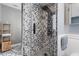 Modern shower with patterned tile, glass enclosure, and a sleek black shower head with body jets at 2945 Southgate Ter, Orlando, FL 32818