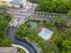 An aerial view shows the community amenities, including a pool, playground, and basketball court amid lush landscaping at 306 Balfour Dr, Winter Springs, FL 32708