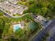 An aerial view shows the community amenities, including a pool, playground, and basketball court amid lush landscaping at 306 Balfour Dr, Winter Springs, FL 32708