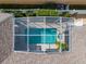 Aerial view of the screened-in pool with a well-maintained deck and lush surrounding landscaping at 306 Balfour Dr, Winter Springs, FL 32708