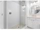 Bright bathroom featuring a glass enclosed shower with white subway tile and white marble vanity with oval mirror at 306 Balfour Dr, Winter Springs, FL 32708