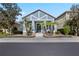 Charming blue single-Gathering home with a well-manicured front yard and inviting entryway with palm trees at 306 Balfour Dr, Winter Springs, FL 32708