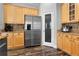 Kitchen featuring stainless steel refrigerator, granite countertops, wood cabinets and a walk-in pantry at 306 Balfour Dr, Winter Springs, FL 32708