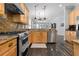 Spacious kitchen with stainless steel appliances, granite countertops, and a seamless connection to living area at 306 Balfour Dr, Winter Springs, FL 32708