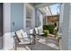 Inviting front porch seating area with comfortable chairs and stylish decor and view of the side yard landscaping at 306 Balfour Dr, Winter Springs, FL 32708
