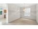 Bright dining area with view to kitchen and window offering ample natural light at 307 Monterey St, Kissimmee, FL 34759