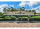 Community entrance sign with lush landscaping under a sunny sky at 307 Monterey St, Kissimmee, FL 34759