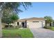 Charming single-story home with tile roof, stone accents, well-manicured lawn and brick paver driveway at 307 Monterey St, Kissimmee, FL 34759