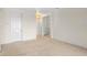 An ample, carpeted living room showcases white walls and trim with entry to hallway at 307 Monterey St, Kissimmee, FL 34759