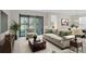Comfortable living room with neutral tones, sliding glass doors, and view of outdoor space at 307 Monterey St, Kissimmee, FL 34759